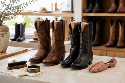 Brown and black cowboy boots with cedar boot shapers brush cloth and conditioner for preventing creases